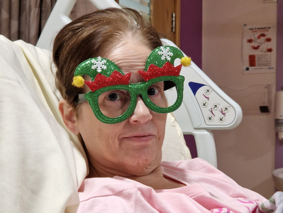 Ben's mum wearing green sparkly Christmas glasses