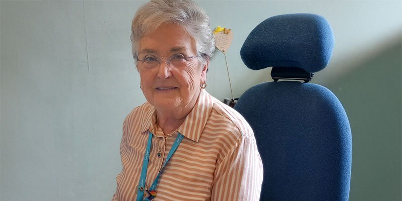Elizabeth at reception desk at the Sue Ryder Hospice