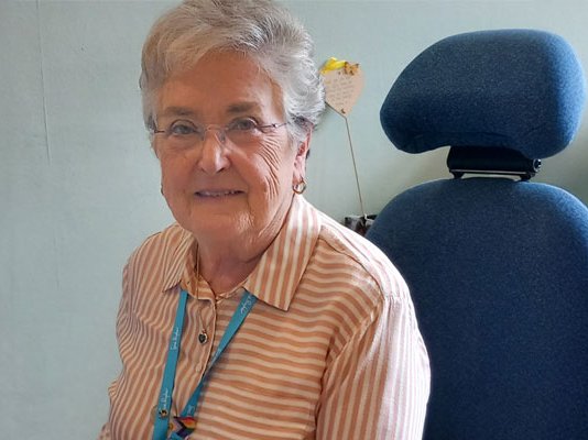 Elizabeth at reception desk at Sue Ryder St John's Hospice
