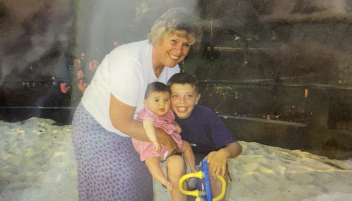Ellen's mum posing for a photo with Ellen her brother outdoor