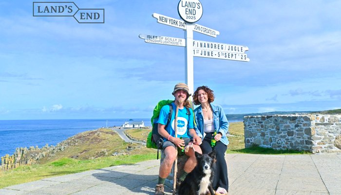Finley posing with Lauren and his dog Reggie celebrating reaching the Land's End