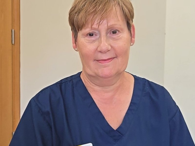 Hazel King Sue Ryder palliative care nurse wearing navy uniform