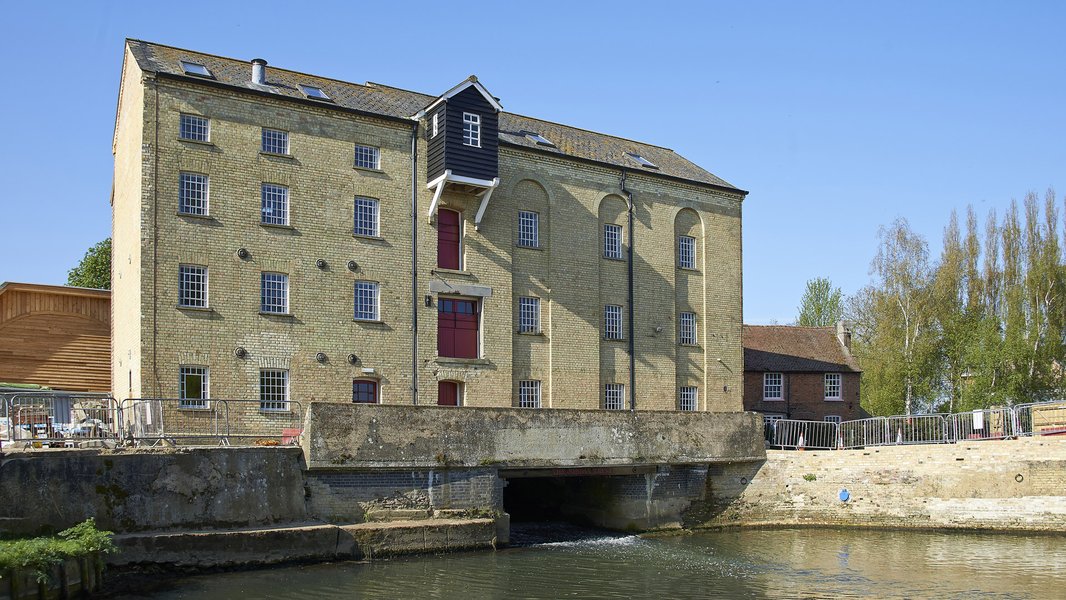An exterior view of Jordans Mill, with water rushing down