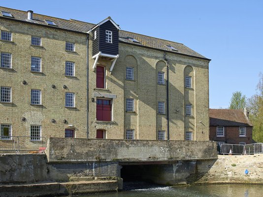 An exterior view of Jordans Mill, with water rushing down