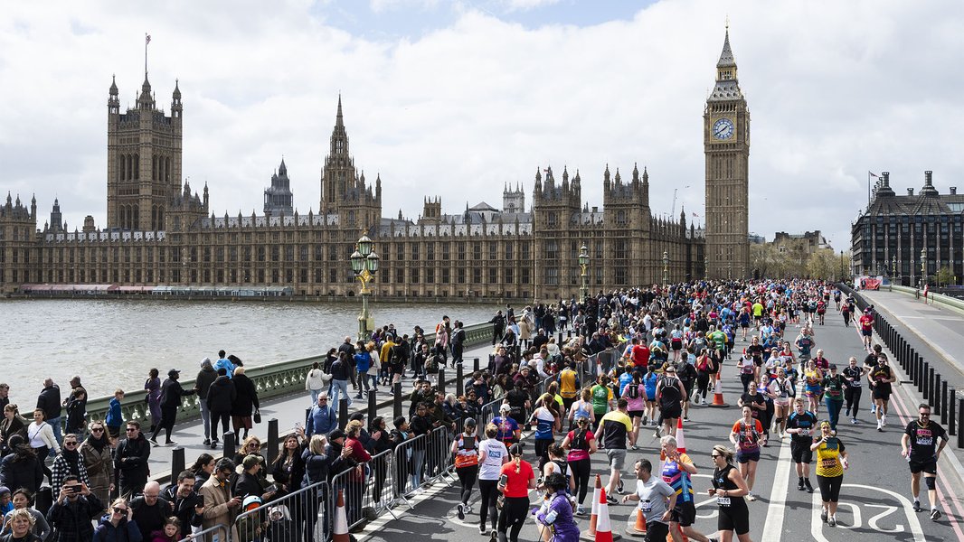 London Landmark Half Marathon runners racing over a bridge towards the Houses of Parliament