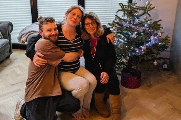 Phil's family by Christmas tree at home