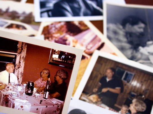 Lots of photographs of family members and loved ones from a scrapbook