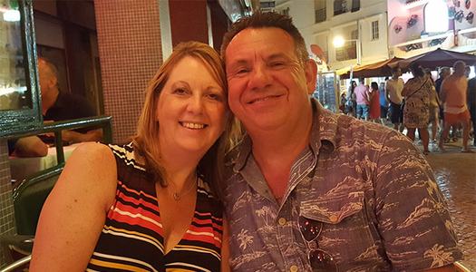 Jo and Brian smiling together in a restaurant
