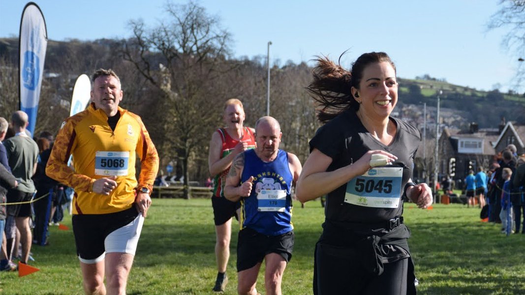 Runners competing in the Keighley 10k race, surrounded by crowds on either side