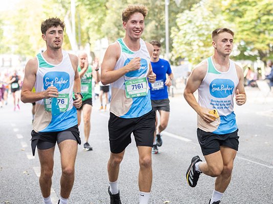 Three Sue Ryder runners racing together during the Run Cheltenham event