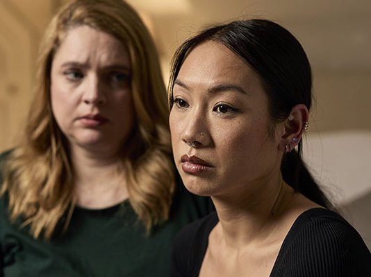 Two women sit together after a bereavement